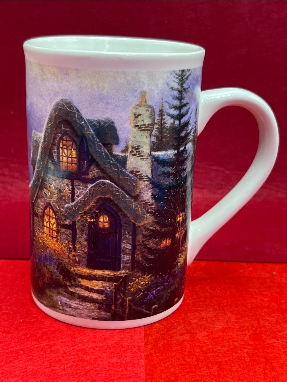 Thomas Kinkade White Ceramic Cottage Mug with Warm Amber and Deep Blue Accents